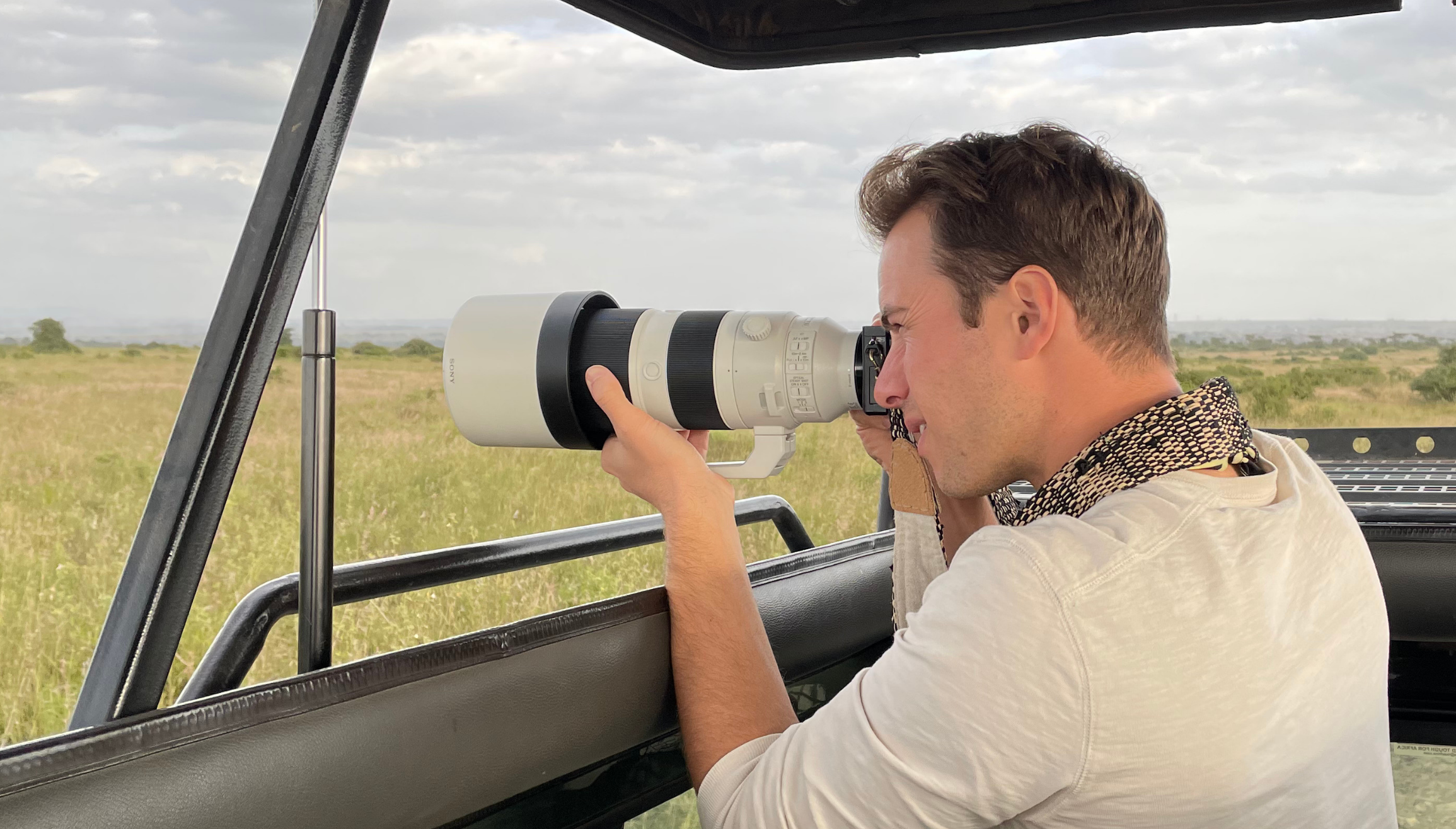 man photographing wildlife on safari