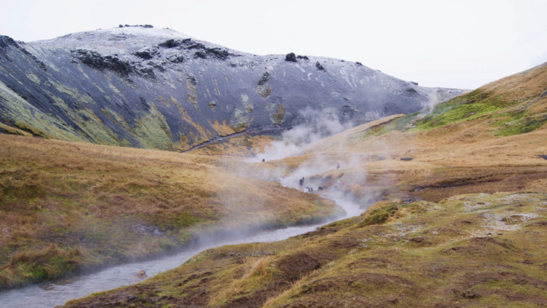 Tourists soaking in the natural Reykjadalur Hot Springs of Iceland